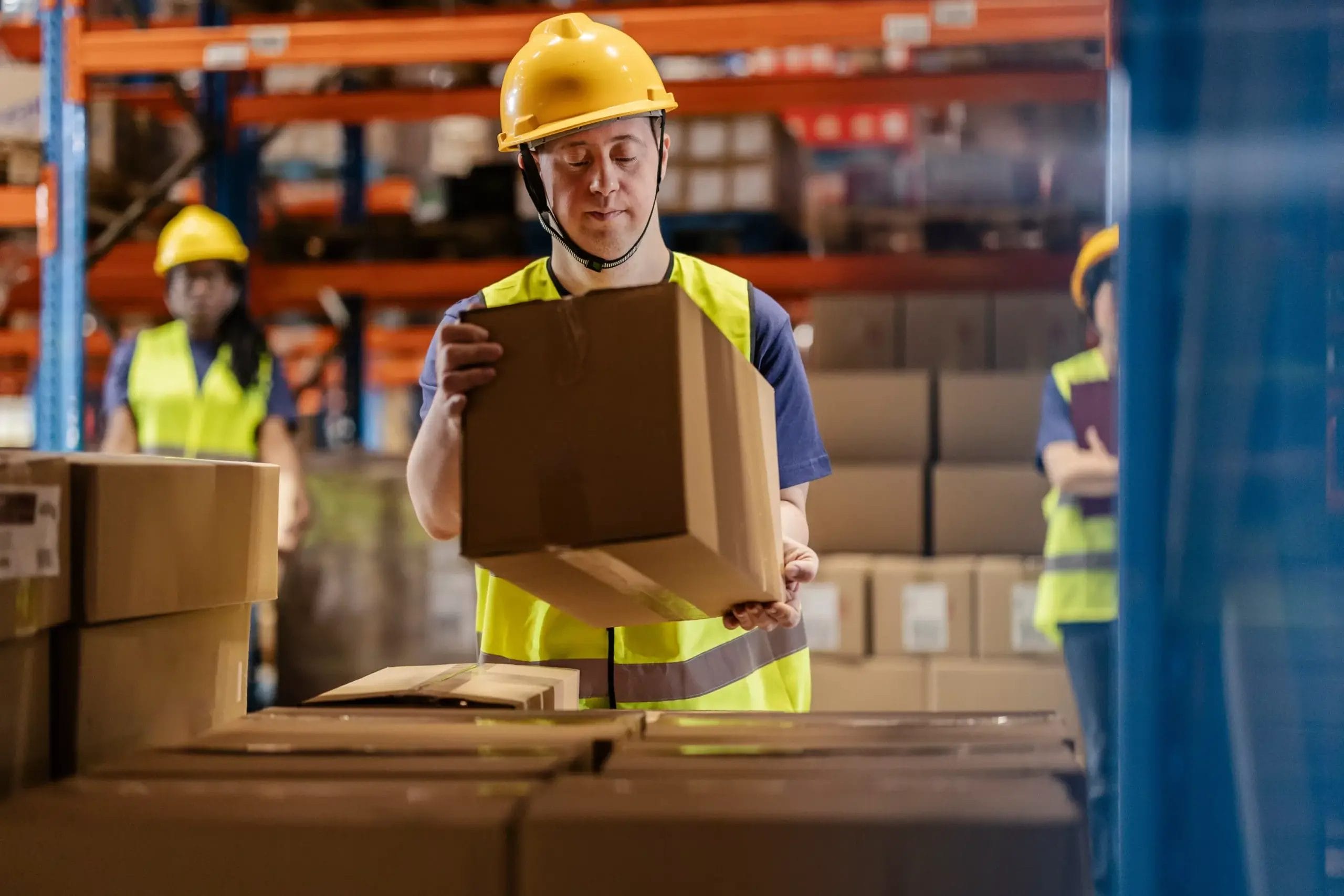 Warehouse,Worke,In,Safety,Gear,Moving,A,Box,,Promoting,Workplace